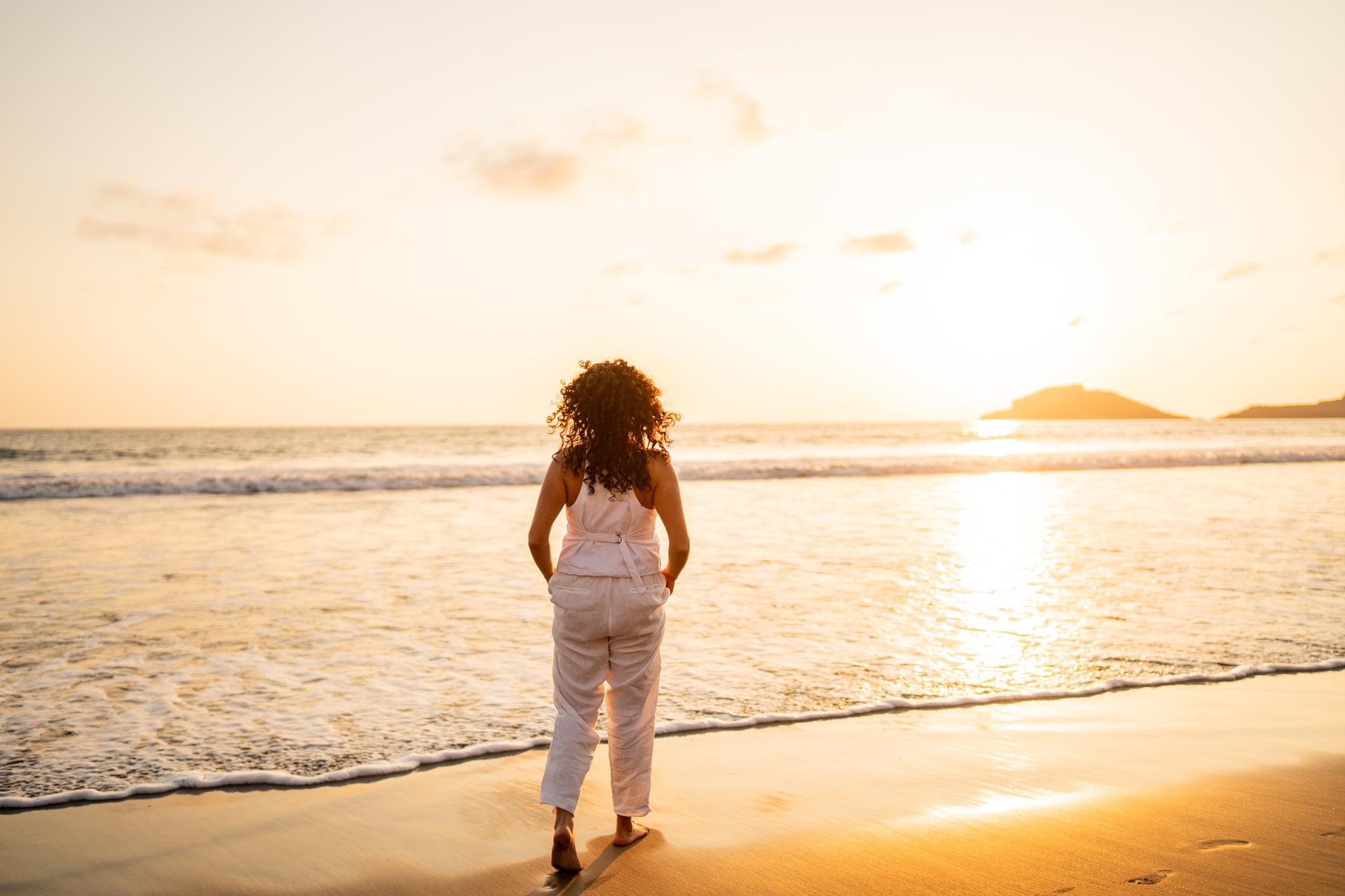 woman on beach at sunset